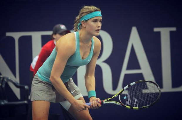 Genie Bouchard playing tennis indoors.